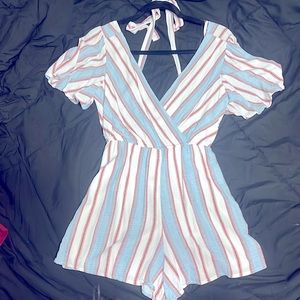 A red, white, and blue romper. Has a belt that ties around the waist.